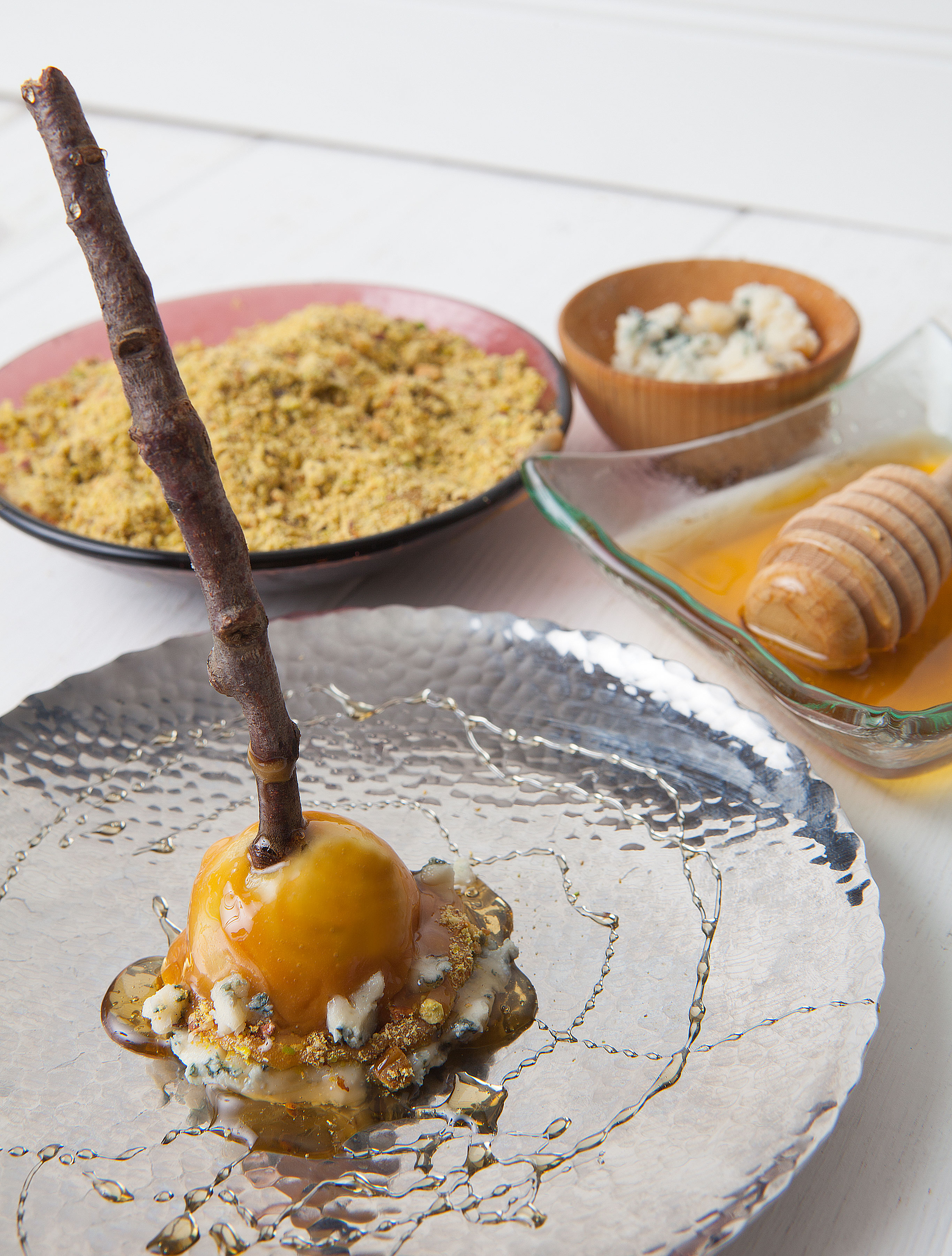 The Lighthouse Dip your Granny Smith apple into melted warm caramel, and swirl to coat evenly. Dip caramel coated apple into Pt. Reyes blue cheese crumbles and crushed pistachios. Drizzle coated apple with honey and serve.